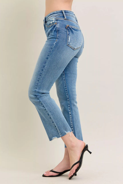 Light blue vintage wash denim jeans with distressed hem and kick flare fit