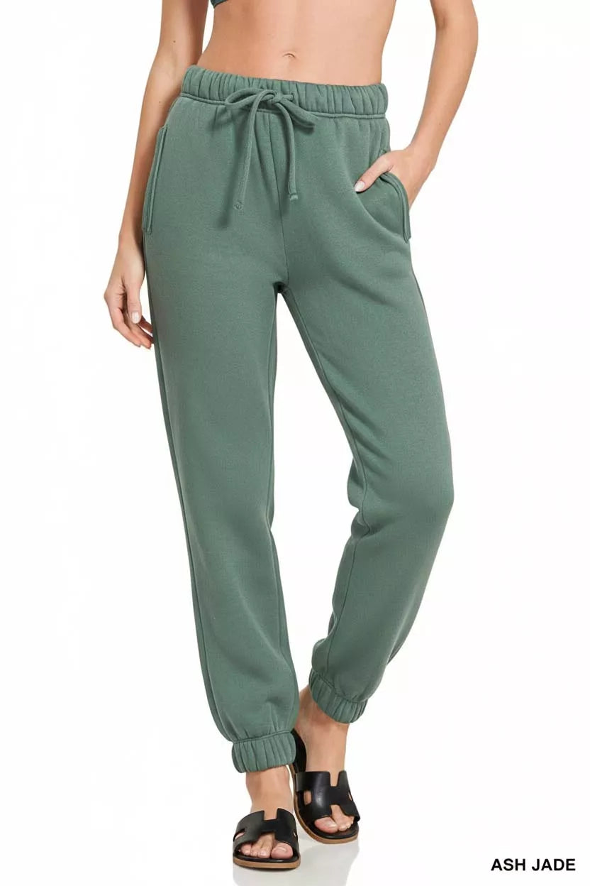 Close-up of soft ash jade green fleece joggers elastic cuff detail