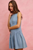 Light blue denim sleeveless mini dress with fitted waist and flared skirt.