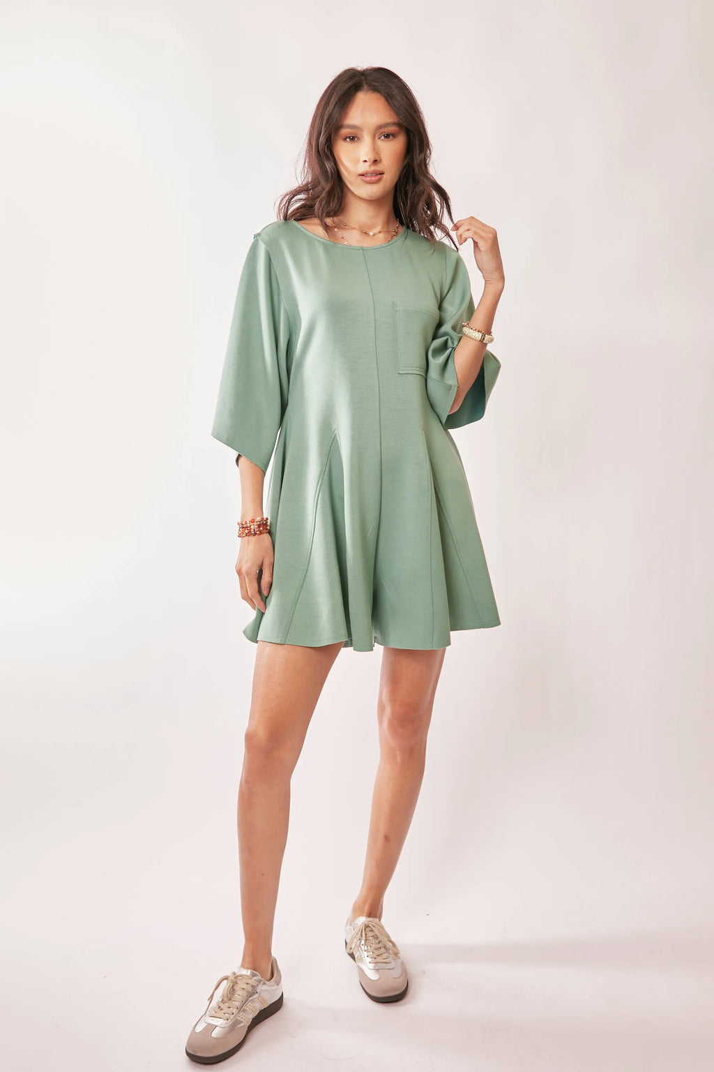 Seafoam green romper with draped sleeves and soft fabric details