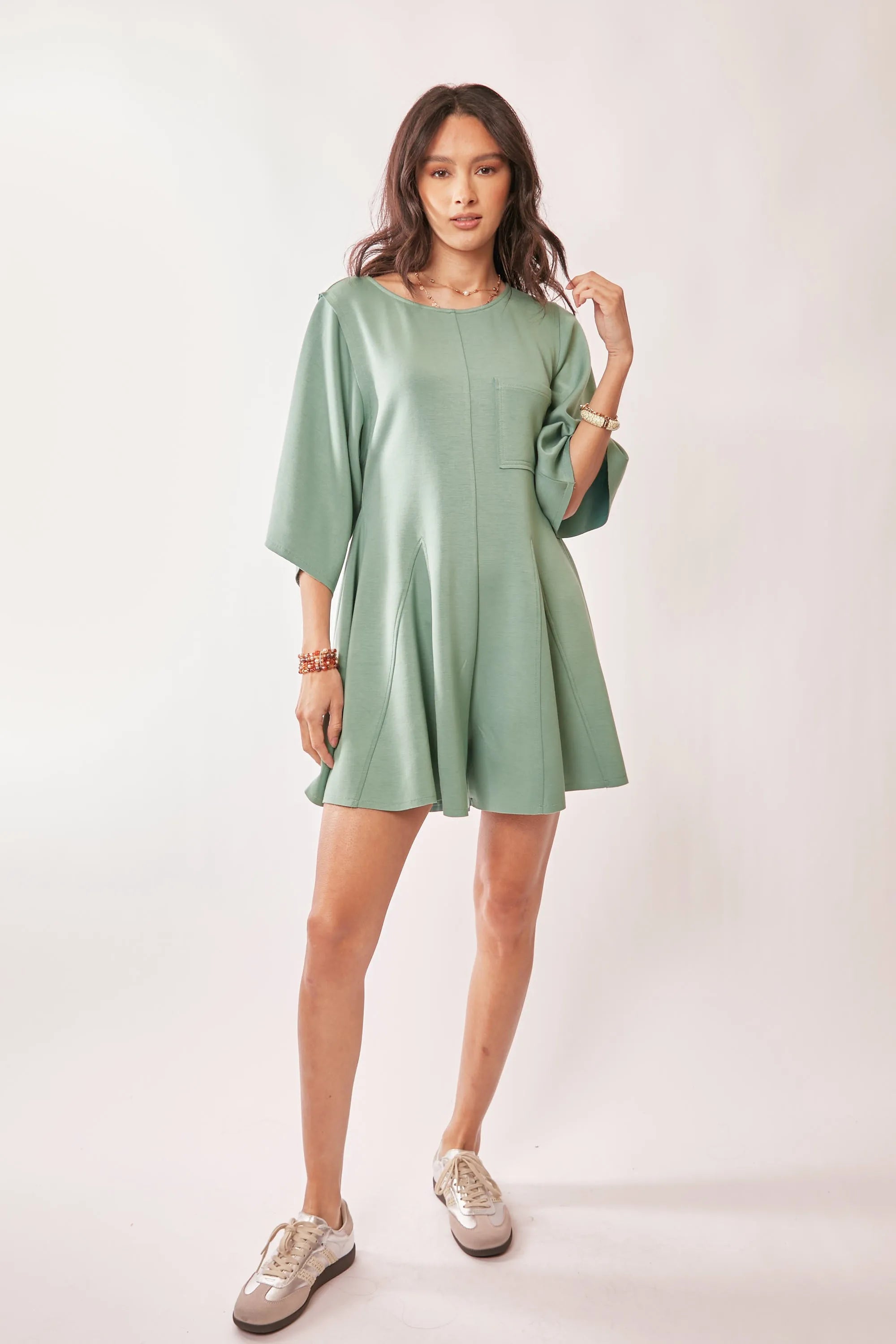 Seafoam green romper with draped sleeves and soft fabric details