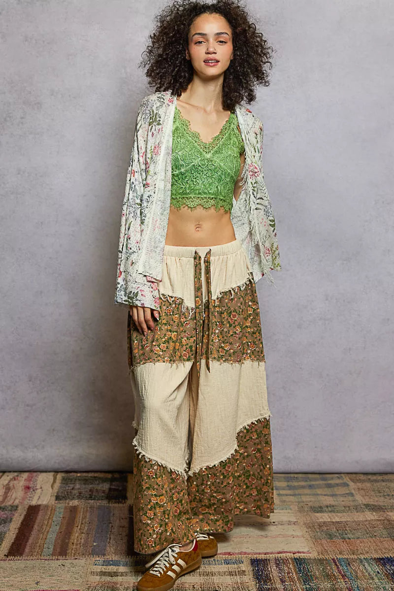 Front view of floral fringe cardigan with open neckline