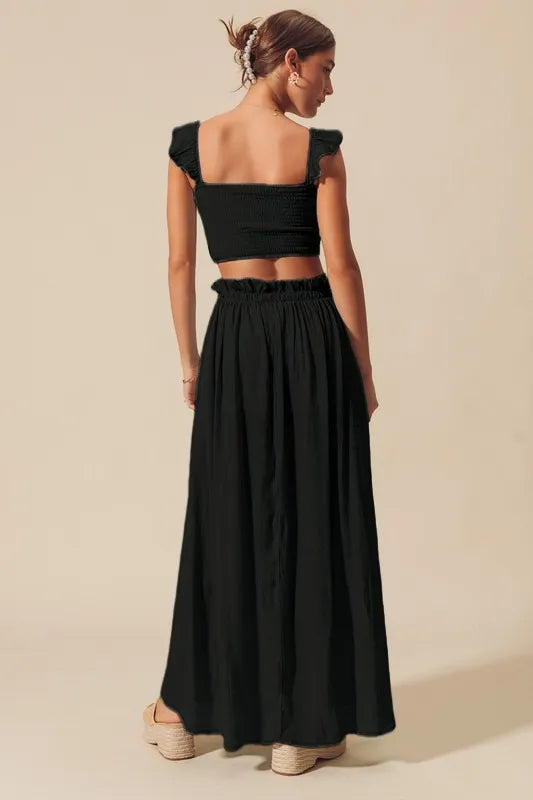 Charcoal black two-piece set featuring cropped top and airy maxi skirt