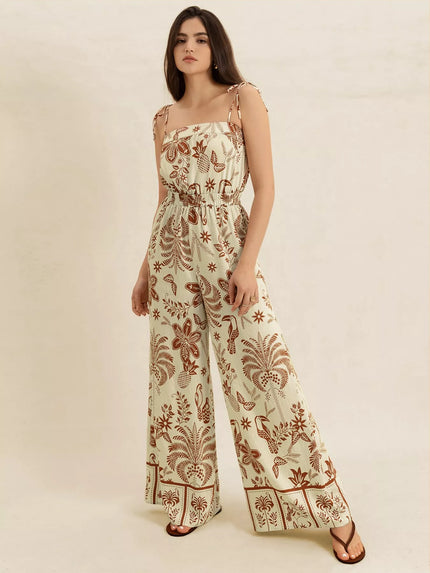Cream base tropical print wide leg jumpsuit with tie straps and smocked waist