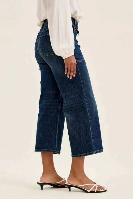 Dark blue durable cotton blend utility jeans with high waist, wide crop fit, patch pockets, and elongating leg shape