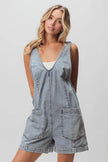 Light-wash denim shortall with patch pockets and relaxed fit.