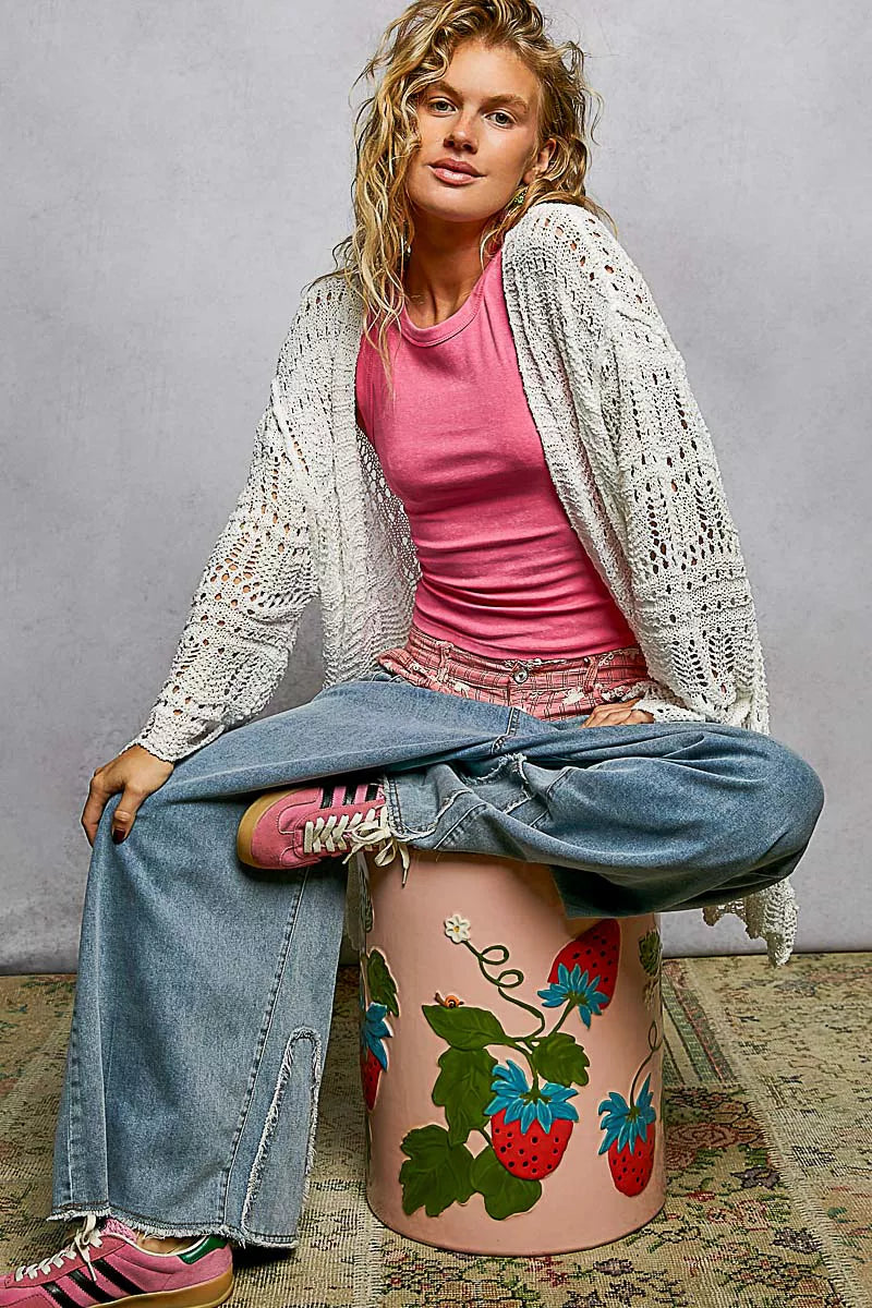 White openwork cardigan with scalloped edge, lightweight knit, loose fit, airy texture.