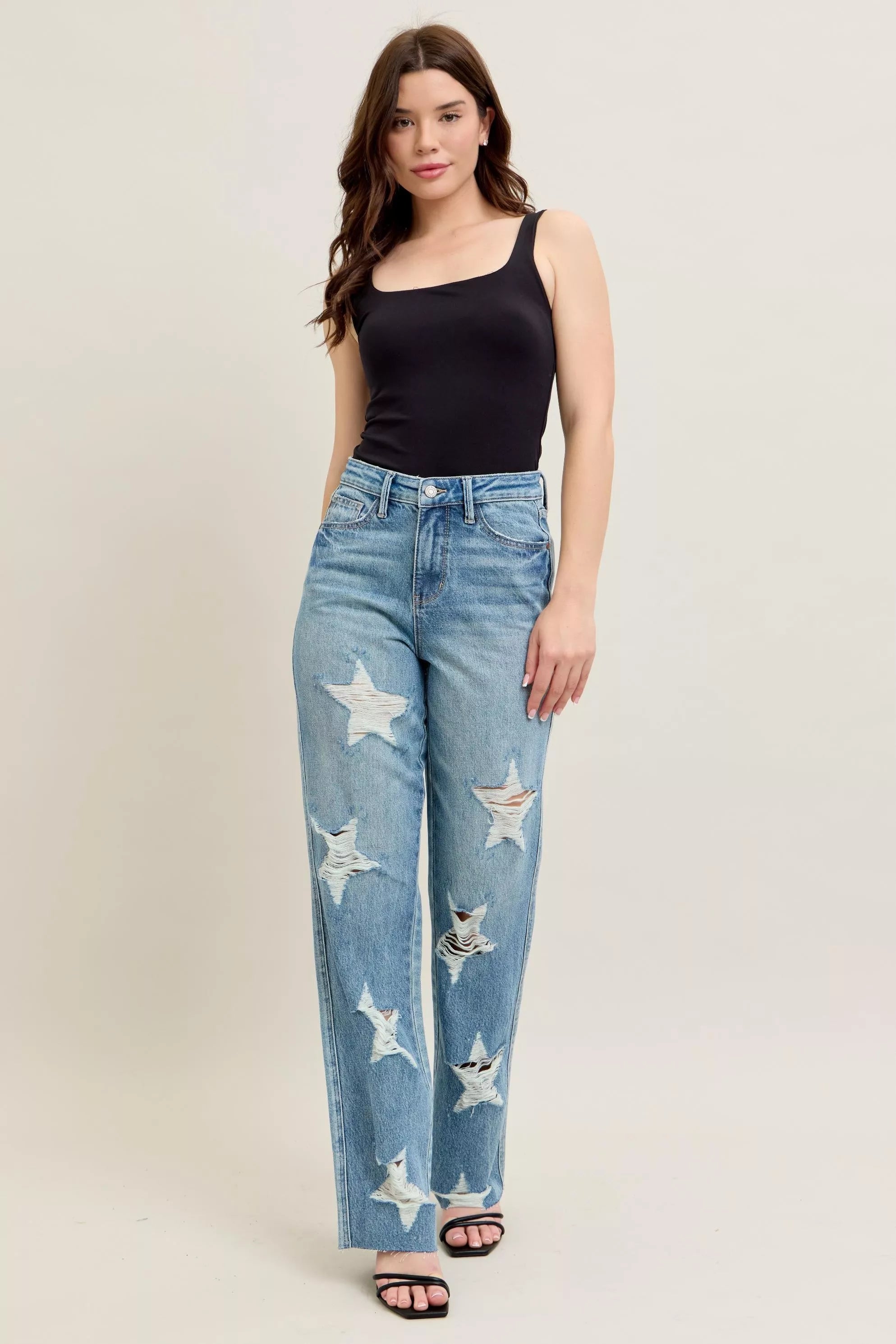 90s straight-leg high-waisted denim with rigid distressed star, bird embroidery, and light wash texture.