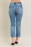 Light blue denim jeans with distressed hem and vintage wash texture, slim fit with kick flare.