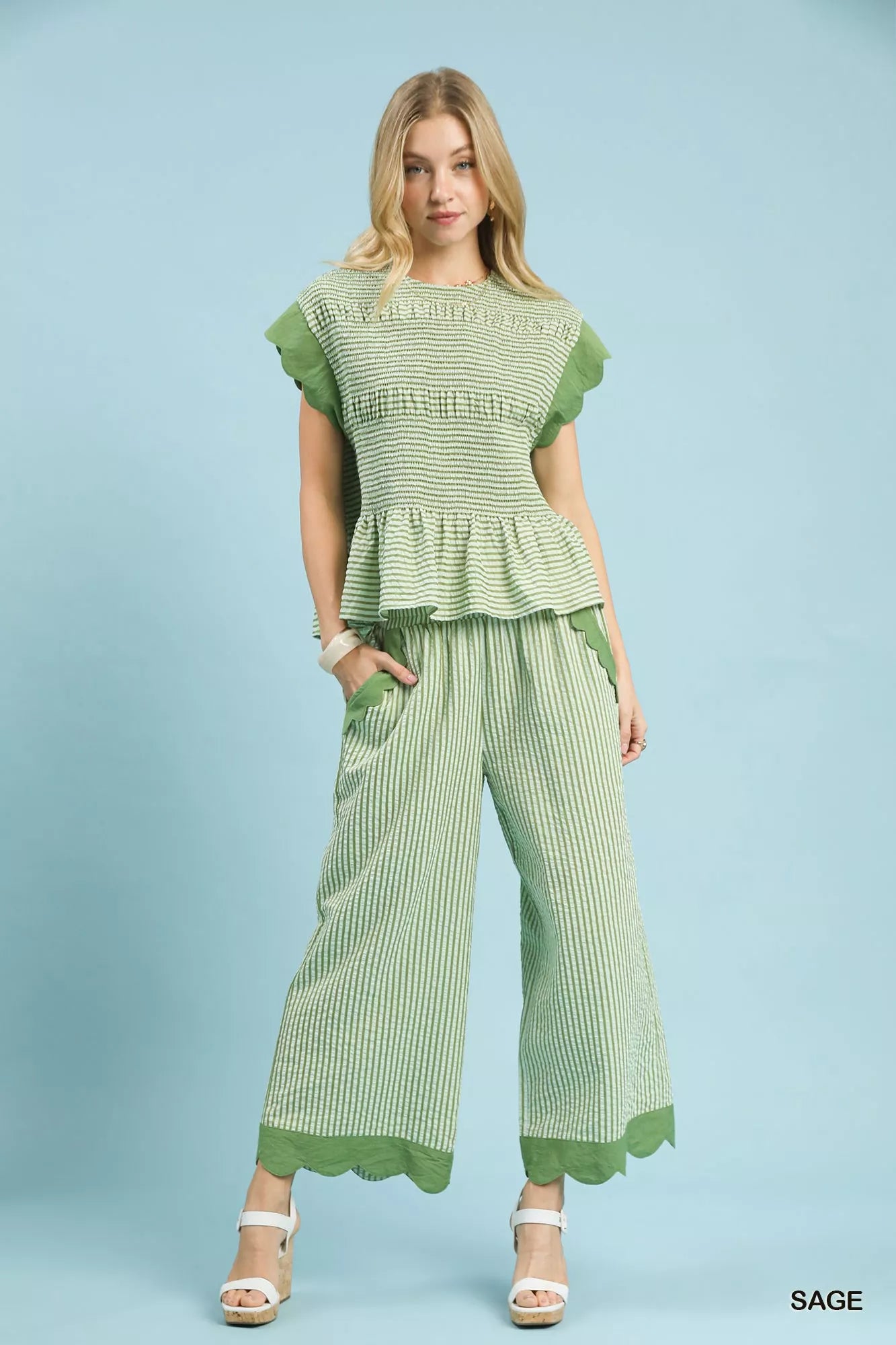 Ruffled pocket detail on sage green wide-leg pants