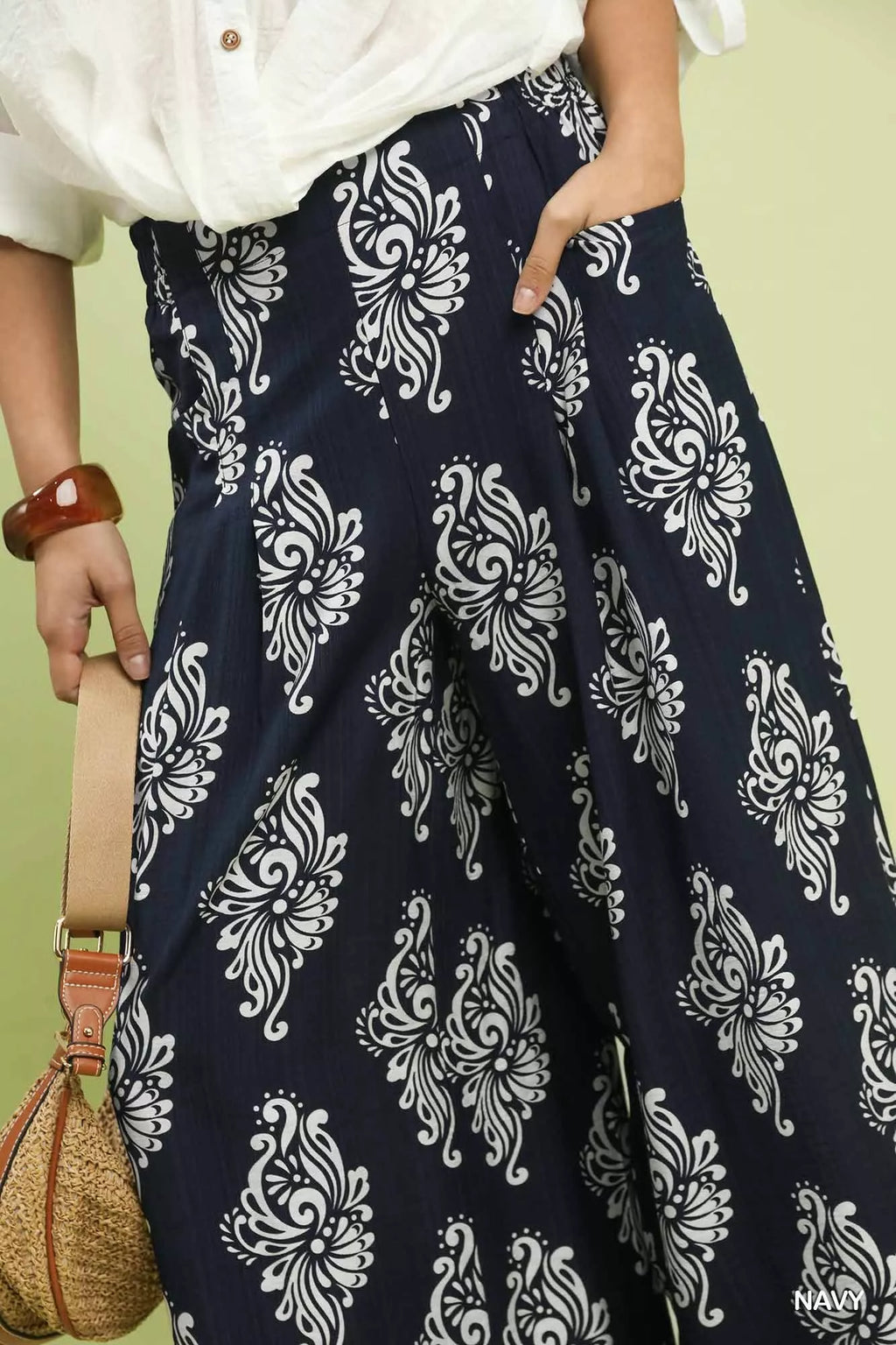 Side pockets on navy wide-leg pants with abstract design