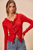 Red ribbed sweater with cascading ruffles, fitted cut, denim pair