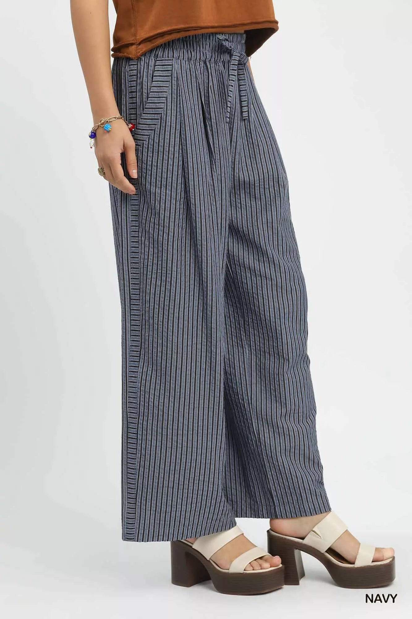 Close-up of drawstring waist on striped wide-leg pants