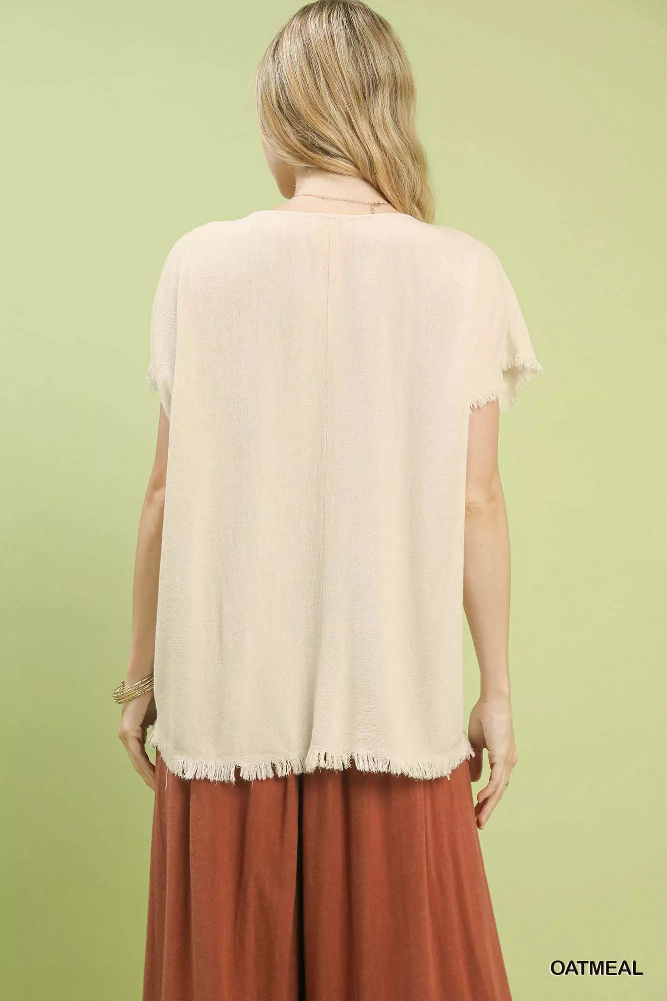 Relaxed fit linen top showcasing raw frayed hem detail