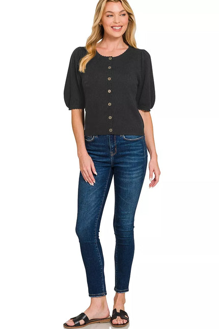 Close-up of ribbed button details on black wool cardigan