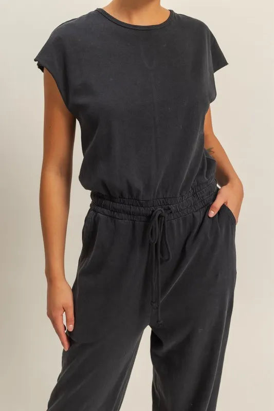 Versatile black jumpsuit with adjustable drawstring and side pockets