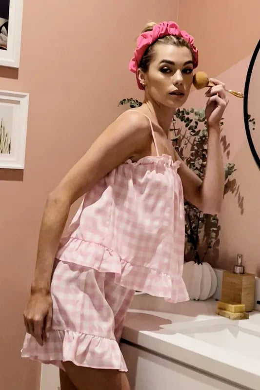 Close-up of ruffled trim on blush pink gingham pajama cami