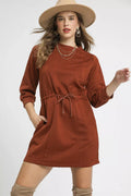 Rust orange cable-knit mini dress with drawstring waist and front pockets