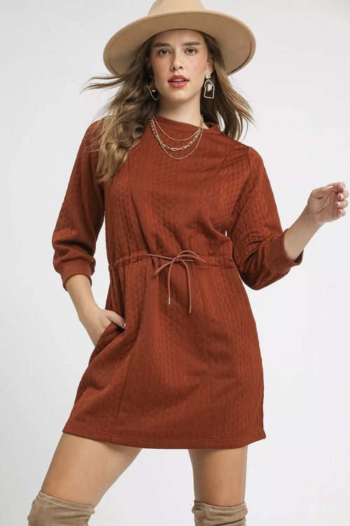 Rust orange cable-knit mini dress with drawstring waist and front pockets