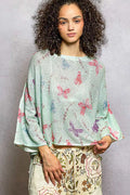 Mint green butterfly-printed knit top with ribbed neckline