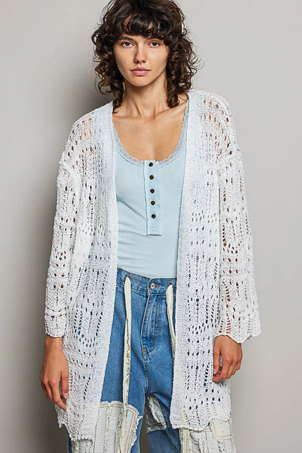 White openwork cardigan with scalloped edge, lightweight knit, loose fit over light blue top and distressed jeans.
