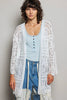 White openwork cardigan with scalloped edge, lightweight knit, loose fit over light blue top and distressed jeans.