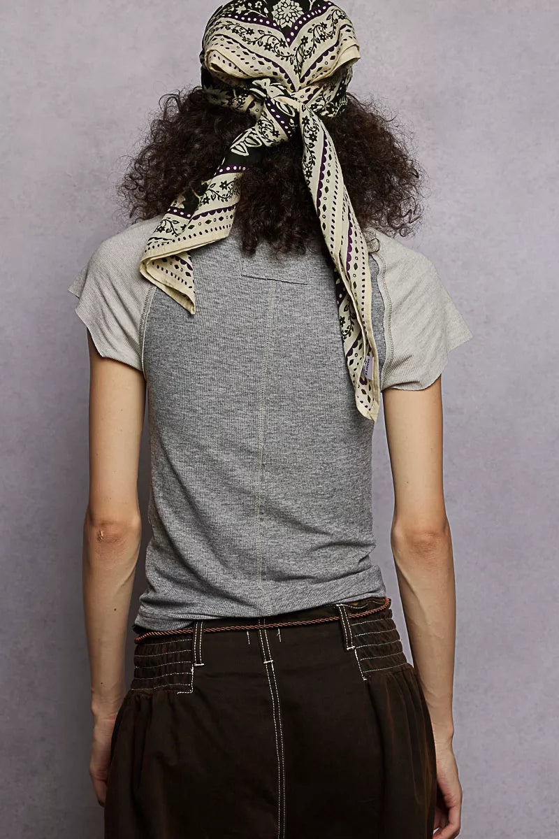 Slightly stretched T-shirt showcasing contrast sleeve and ribbed neck detail