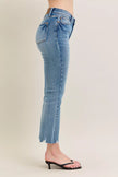 Light blue vintage wash denim jeans with distressed hem and tapered fit