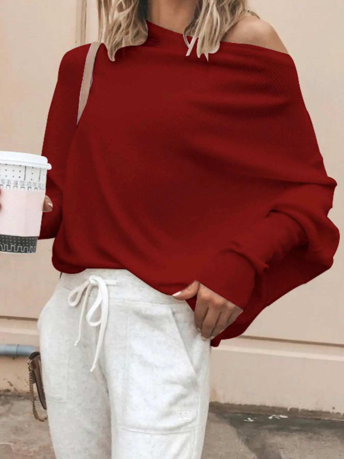 Oversized ribbed knit top with subtle pattern and relaxed silhouette